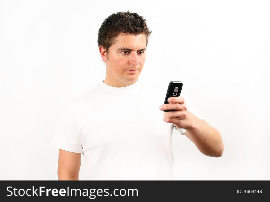 Young man checking the mobile phone over white. Young man checking the mobile phone over white
