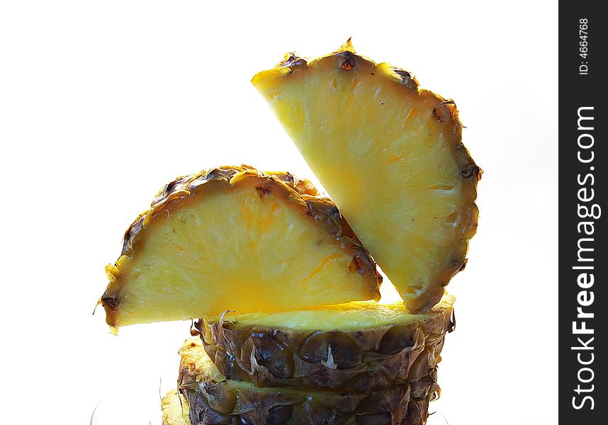 Pineapple cut on a part on a white background isolated. Pineapple cut on a part on a white background isolated