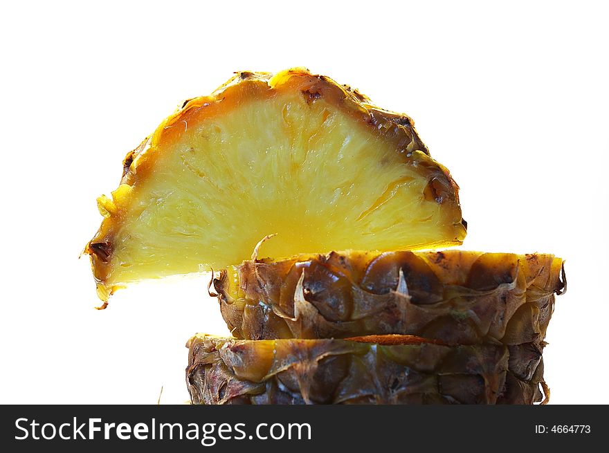 Pineapple cut on a part on a white background isolated. Pineapple cut on a part on a white background isolated