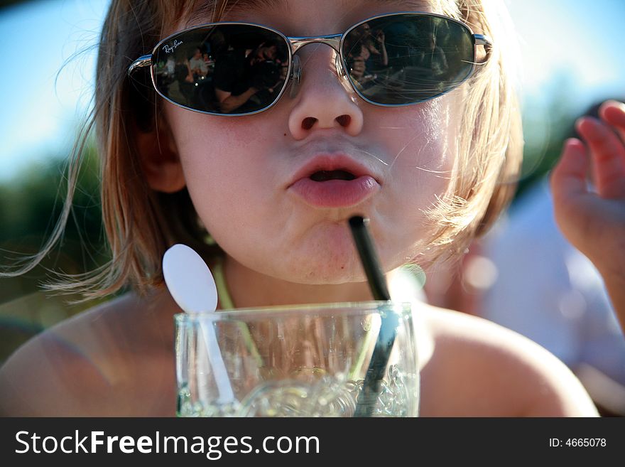 Cool Girl blowing a kiss and drinking on a hot summer day. Cool Girl blowing a kiss and drinking on a hot summer day