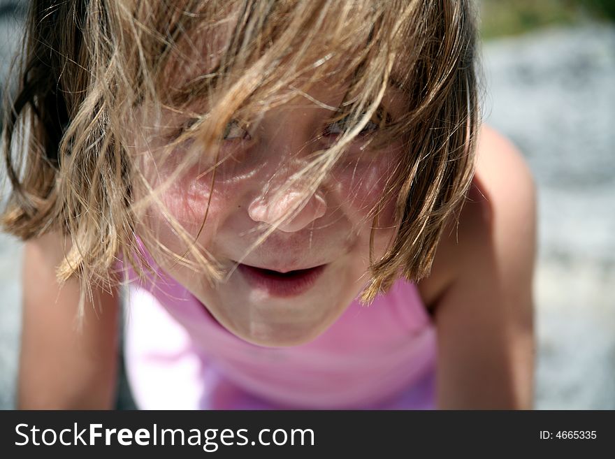 Cool Girl looking at camera with messy hair on a hot summer day. Cool Girl looking at camera with messy hair on a hot summer day