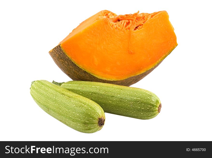 Two zucchini and a slice of pumpkin isolated on white