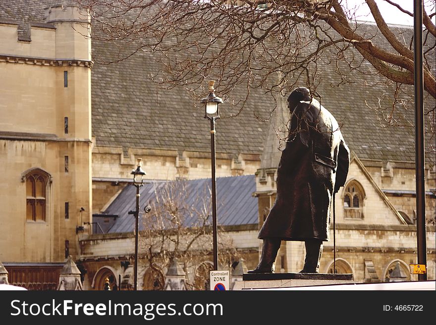 Churchill's statue is in the Houses Parliament square. The old tired men in military coat is going to work in the parliament forever. Churchill's statue is in the Houses Parliament square. The old tired men in military coat is going to work in the parliament forever.