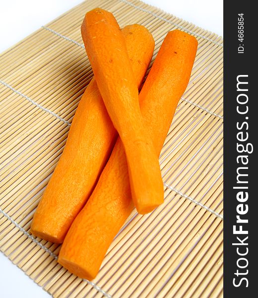 Peeled carrot on bamboo carpet background.