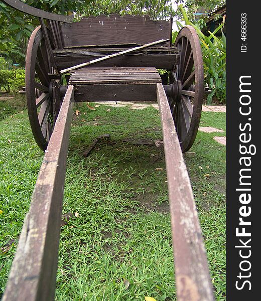 Old cart lying on the grass in the backyard o f a school in Thailand