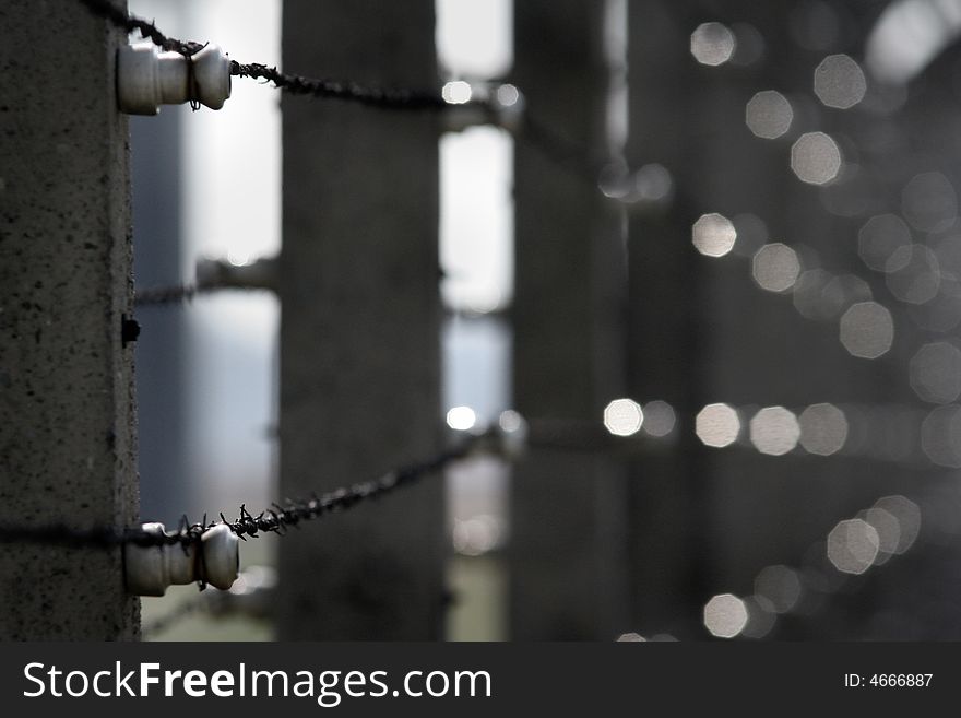 Barbed concrete around prison in the sunny day