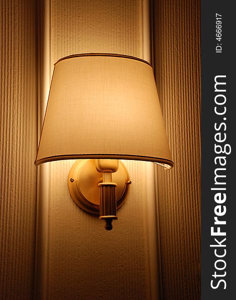Bright lamp on hotel wall in warm colors