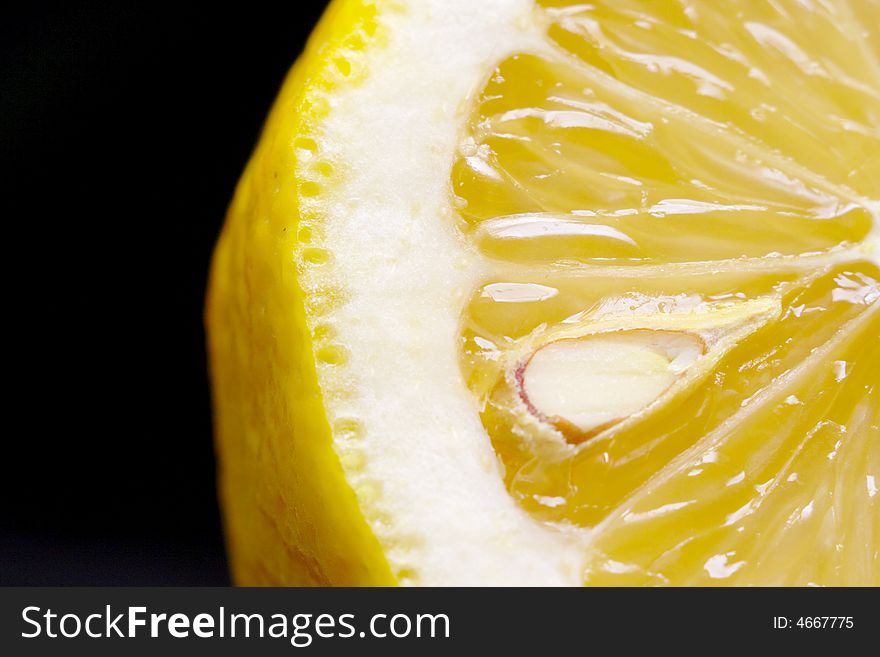 Macro close-up of fresh cut lemon with black background