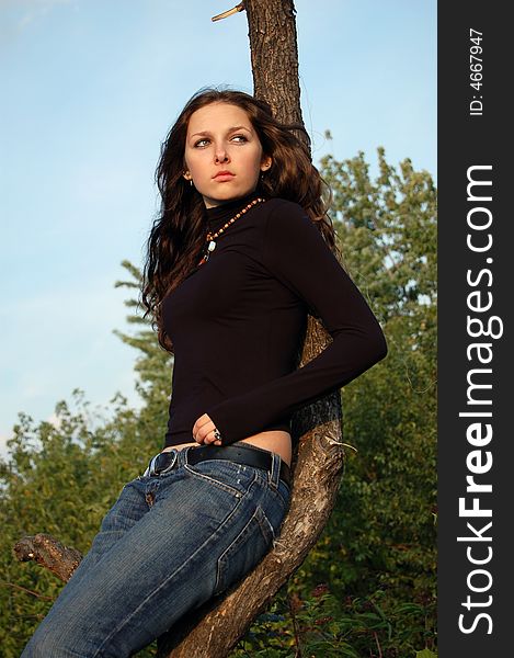 Beautiful teenage girl near the tree