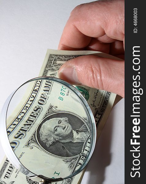 Male hand with one dollar bill and magnifying glass. Male hand with one dollar bill and magnifying glass