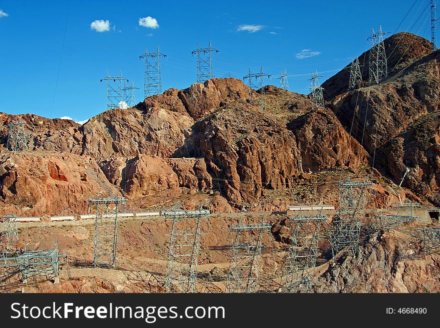 Many electric towers surrounding the area of Hoover Dam. Many electric towers surrounding the area of Hoover Dam.