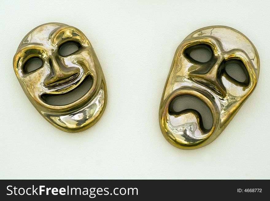 Two golden mask on light blue background. Two golden mask on light blue background