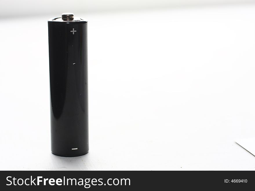 Black AA battery on white background