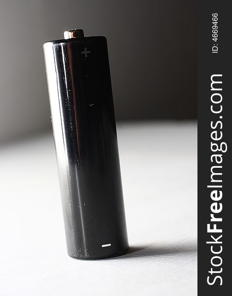 Black AA battery on white background