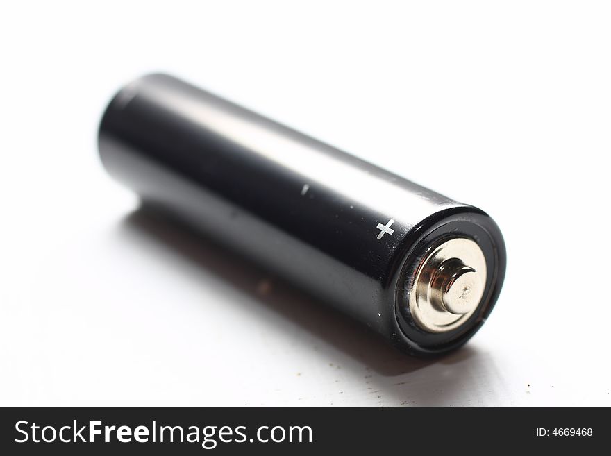 Black AA battery on white background