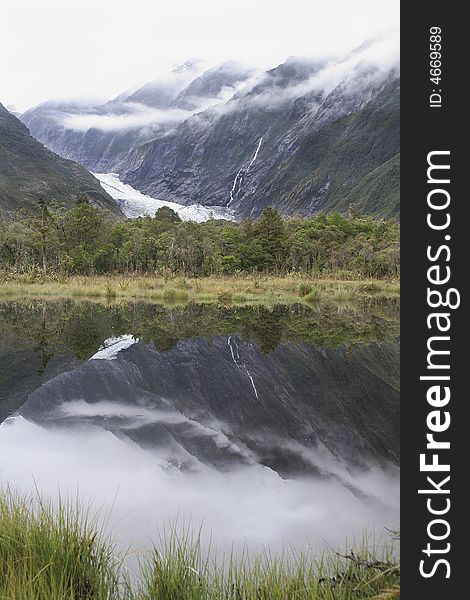 Franz Josef Glacier reflected in Peters pool, West coast< New Zealand. Franz Josef Glacier reflected in Peters pool, West coast< New Zealand