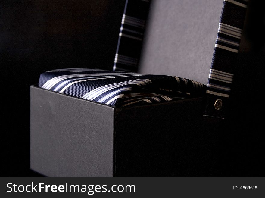 Silk necktie with box, isolated on the black background. Silk necktie with box, isolated on the black background