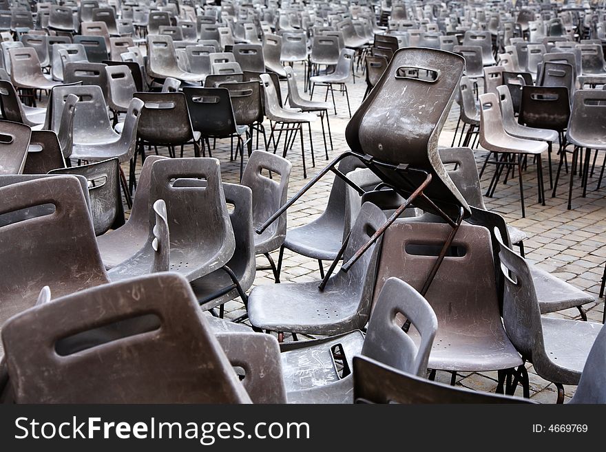 Abandoned plastic chairs after an outdoor event. Abandoned plastic chairs after an outdoor event