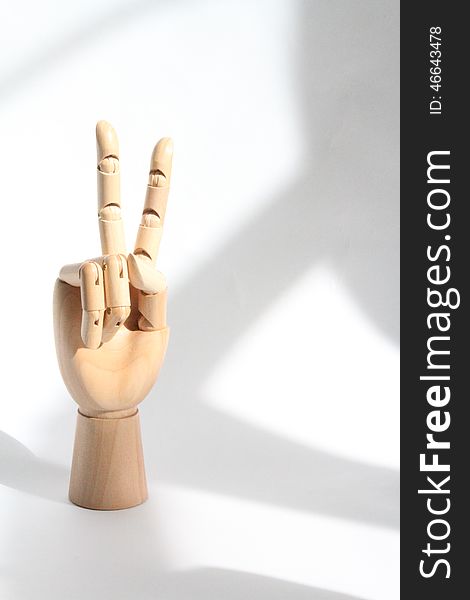 This is a wooden manikin hand modeling the peace sign. This is a wooden manikin hand modeling the peace sign.