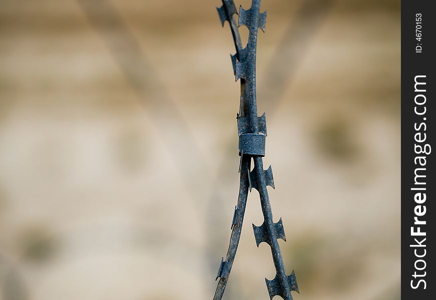 Close up of two strands of barbed wire clasped together