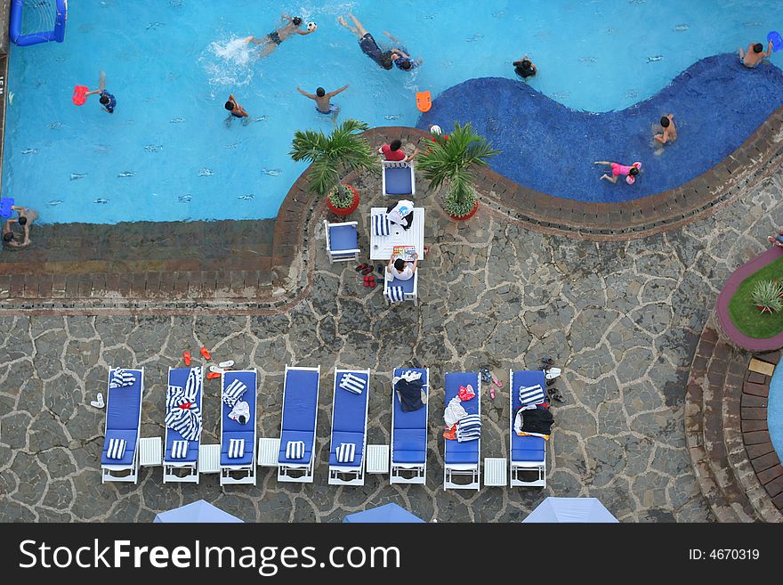 Photograph of pool with people swimming. Photograph of pool with people swimming