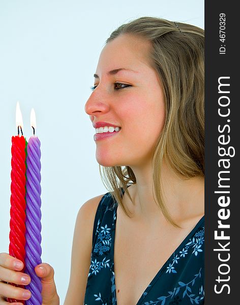 Young gorgeous lady looking at fire of candles. Young gorgeous lady looking at fire of candles