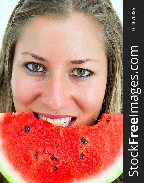 Close-up portrait of a smiling girl eating a red water-melon. Close-up portrait of a smiling girl eating a red water-melon