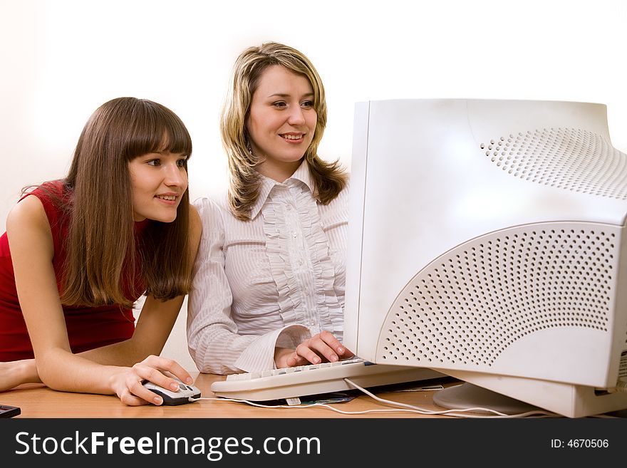 Joyful businesswomen at office looking at computer screen