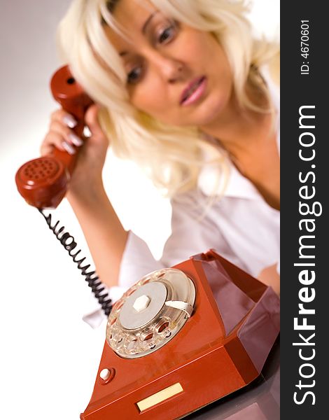 Blond caucasian model with red phone over white