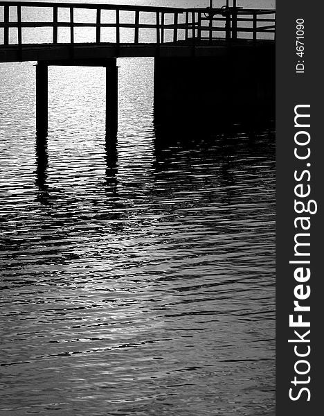 Silhouette of a pier in black and white