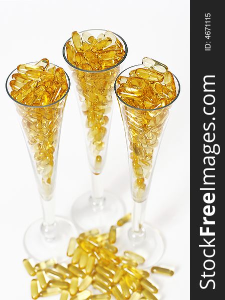 Three glasses with gold shiny boluses. Three glasses with gold shiny boluses