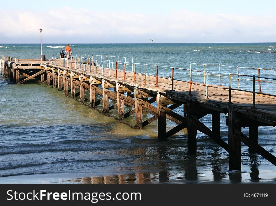 Old rusted ocean Pier at almost low tide