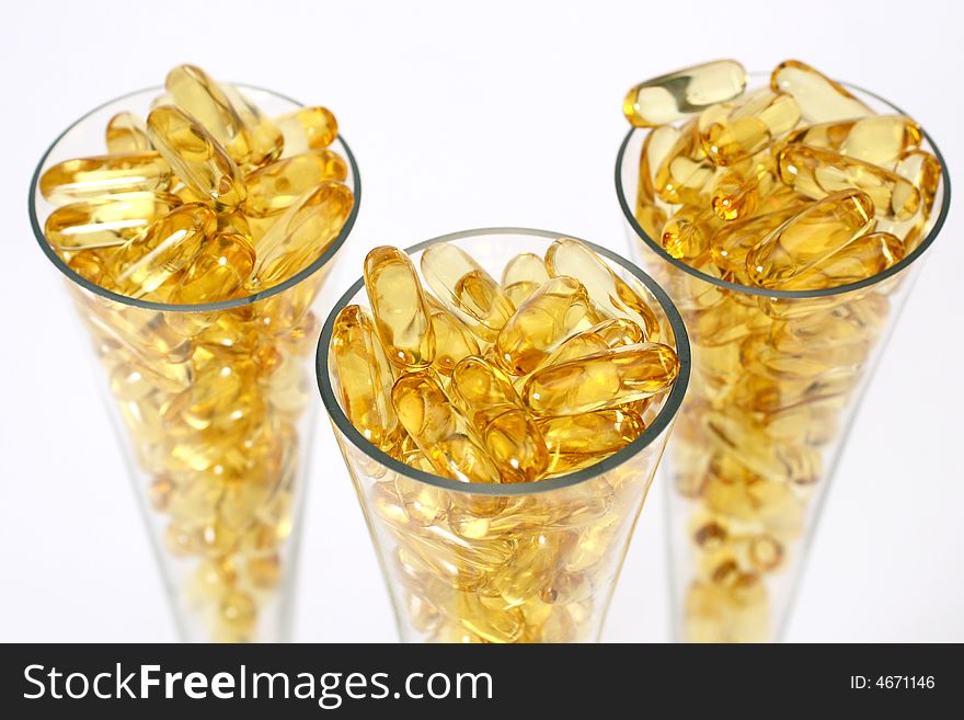 Three glasses with gold shiny boluses. Three glasses with gold shiny boluses