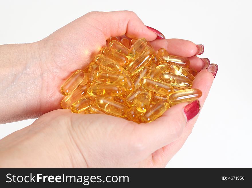 Woman's hands holding gold shiny boluses. Woman's hands holding gold shiny boluses