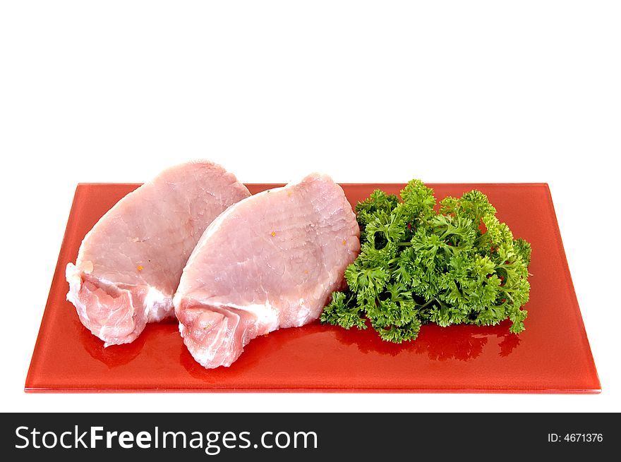 Tenderloin-steak on red plate, white background, studio shot