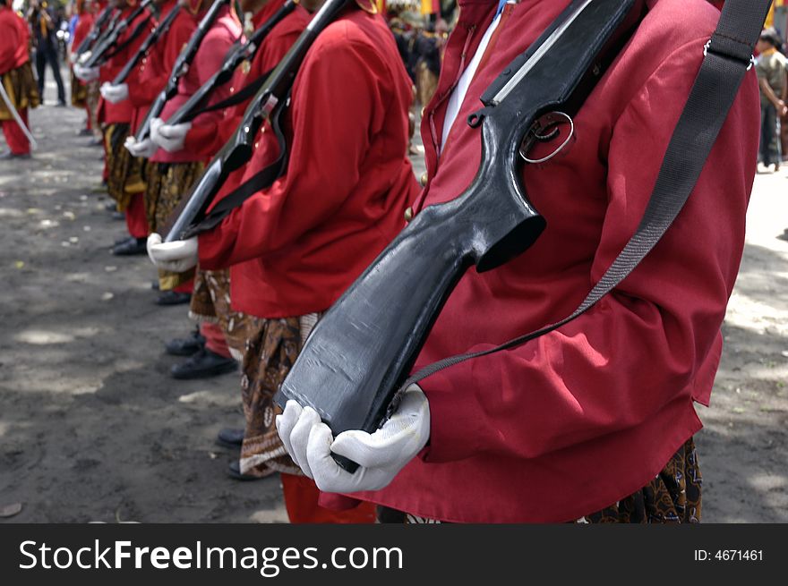 The row of tropper kingdom with old weapon and red uniform at central java, Indonesia. The row of tropper kingdom with old weapon and red uniform at central java, Indonesia