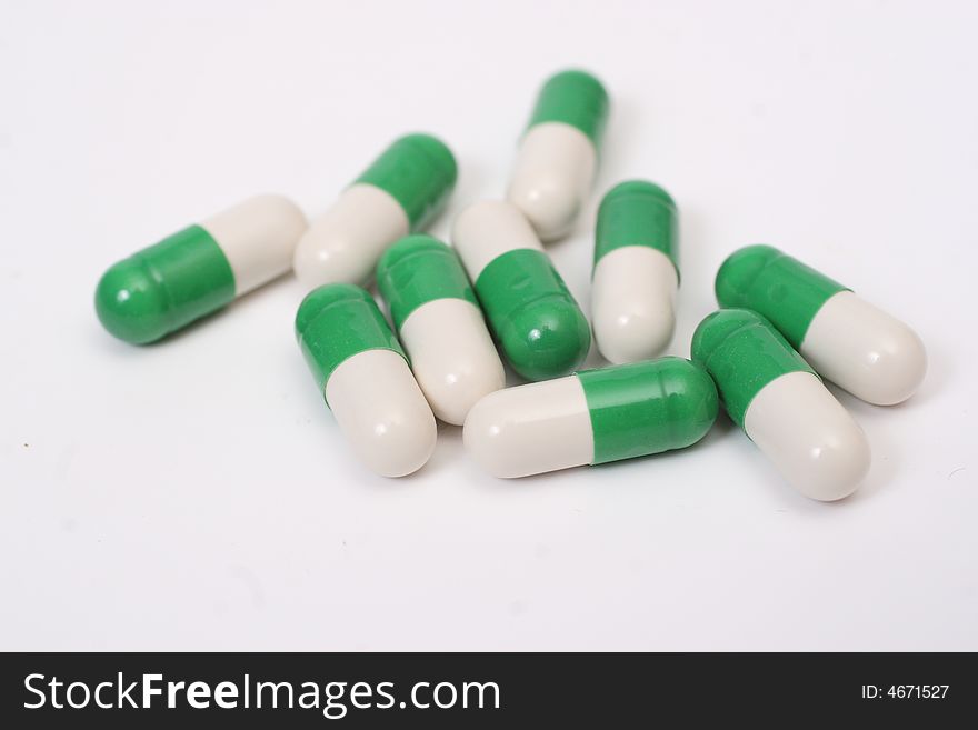 Ten stripy white-green capsules. Ten stripy white-green capsules