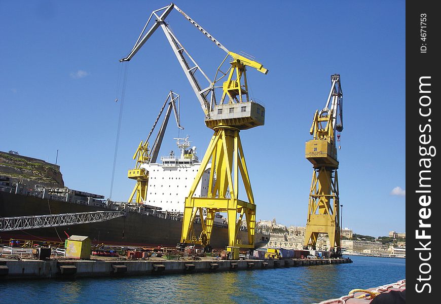 Huge Crane oading a cargo ship in Malta. Huge Crane oading a cargo ship in Malta.