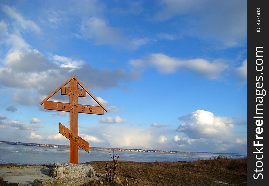 Winter. Wooden christian cross on the coast of the river. Winter. Wooden christian cross on the coast of the river.