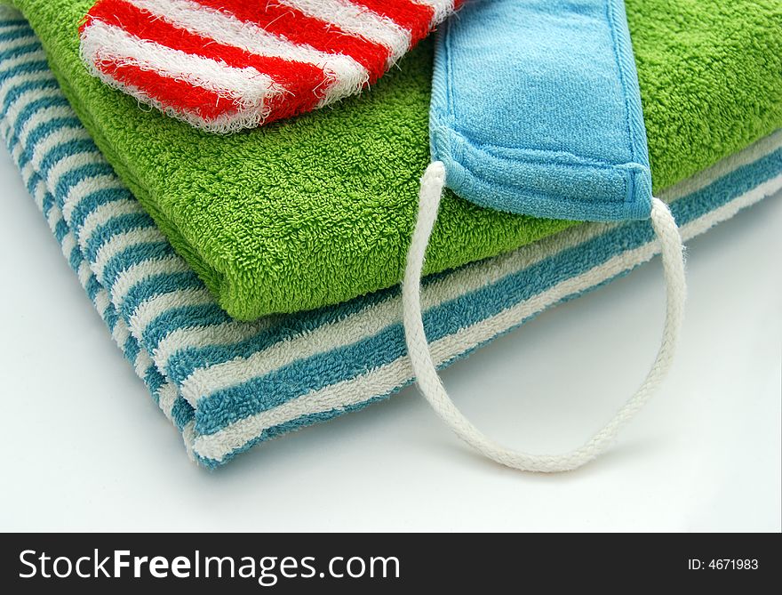 Green and striped towels and scrubbing glove. Green and striped towels and scrubbing glove