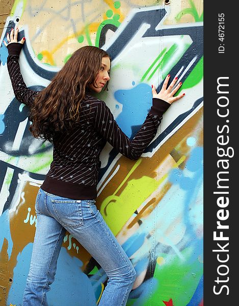 Teenage girl near the graffiti wall
