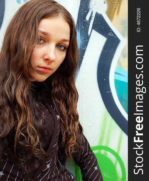 Teenage girl near the graffiti wall