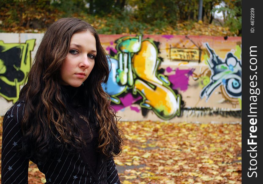 Girl near the graffiti wall