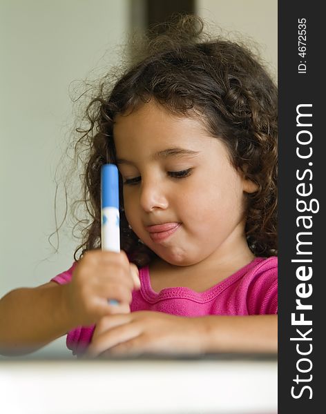 Little girl painting at home