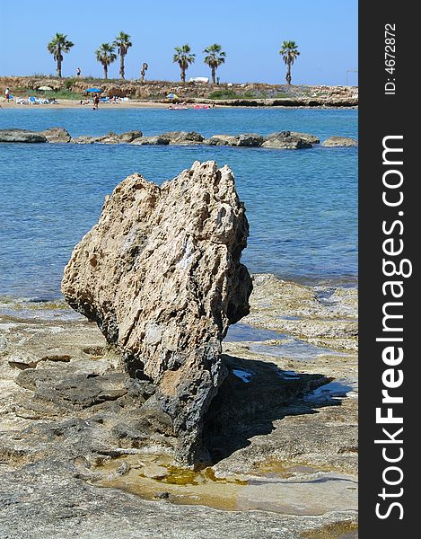 Vertical gray rocky stone on the coastline. Vertical gray rocky stone on the coastline