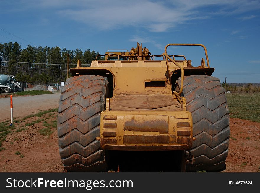 A closeup view of a large construction vehicle. A closeup view of a large construction vehicle