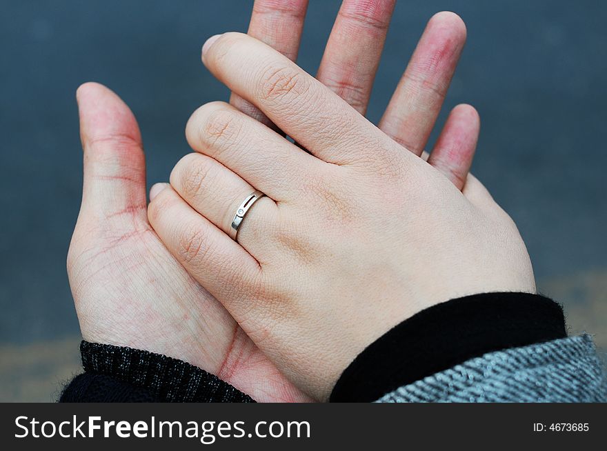 Hands of couple together with rings