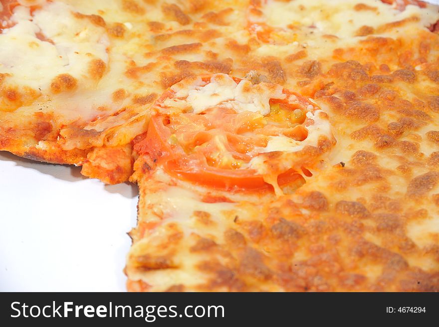 Close up of a pizza which has had a slice cut. Close up of a pizza which has had a slice cut