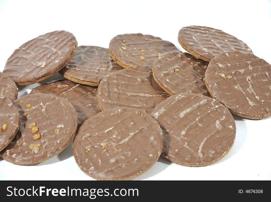 Pile of Chocolate Biscuits on a white background.