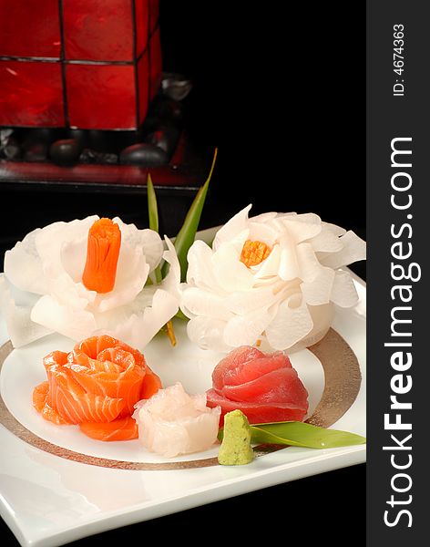 Asian salmon and tuna sashimi with rose shaped dicon flowers. Asian salmon and tuna sashimi with rose shaped dicon flowers